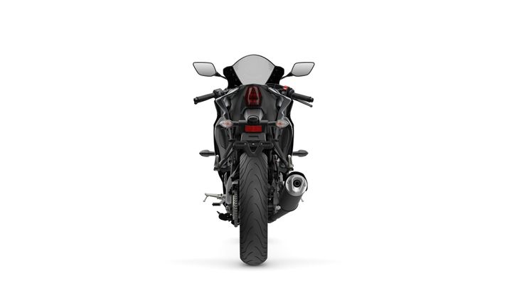 A sleek black motorcycle viewed from the rear, showcasing its dual exhaust, tail lights, and sporty design against a white background.