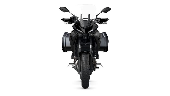 A front view of a black motorcycle with side bags, showing its sleek design and details such as headlights and handlebars against a white background.