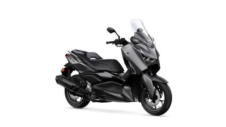 Yamaha 2026 XMAX 300 Tech MAX A sleek, modern scooter with a matte gray finish, featuring a tall windshield, comfortable seating, and sporty design elements, positioned against a white background.
