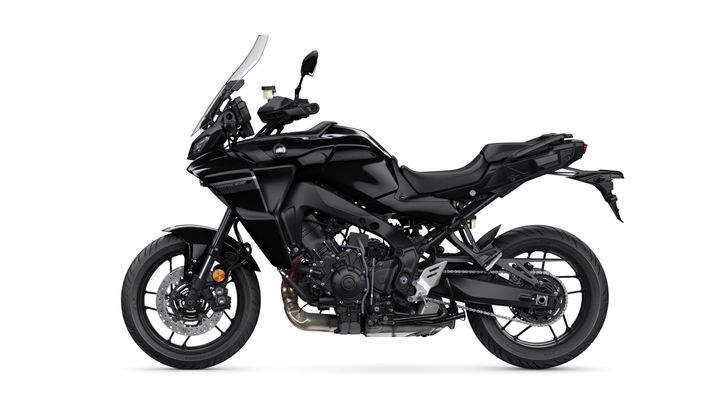 A black touring motorcycle with a sleek design, featuring a large windshield, adjustable seat, and prominent engine details, positioned against a white background.