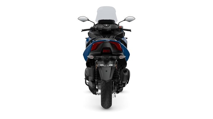 A rear view of a blue motorcycle with a transparent windscreen, showcasing the tail light, exhaust, and tire details against a white background.