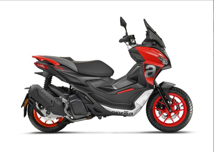 A red and black Aprilia scooter on a white background.