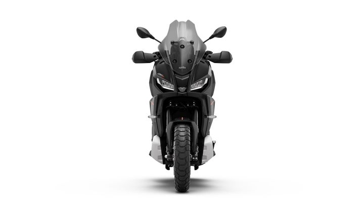 Front view of a sleek black motorcycle with a prominent windshield, headlights, and textured tires on a white background.