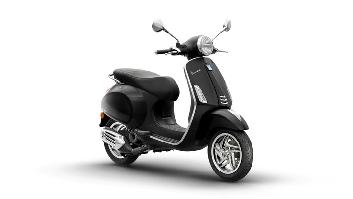 A sleek black Vespa scooter positioned at an angle, showcasing its smooth curves, chrome details, and stylish design.