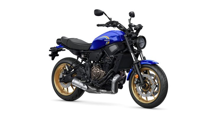 A blue Yamaha motorcycle with a modern design, featuring a black seat and gold-colored wheels, positioned against a white background.