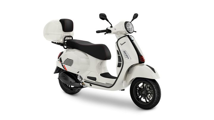 A sleek white scooter with a black seat and red accents, featuring a rear luggage box, modern handlebars, and stylish wheels, positioned at an angle against a white background.