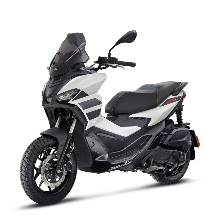 A modern two-wheeled scooter with black and white bodywork, a windscreen, and dual-purpose tires, displayed on a white background.