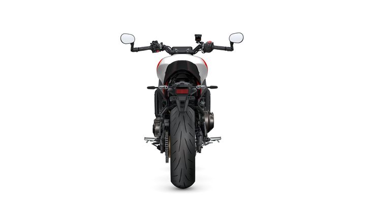 Rear view of a modern motorcycle showcasing the large tire, tail section, and handlebars with mirrors, set against a white background.