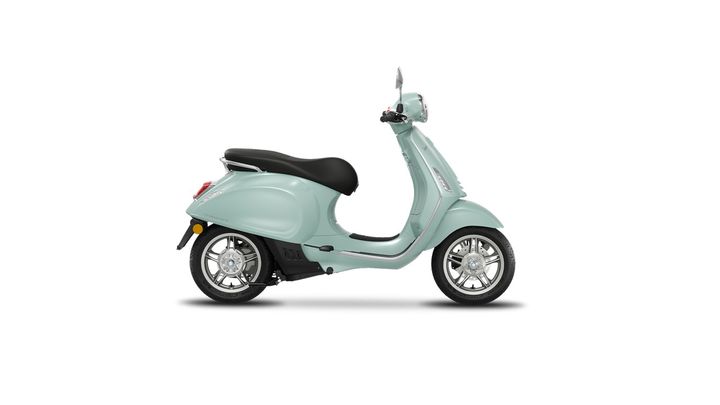 A mint green scooter with a black seat, viewed from the side, showcasing its sleek design and chrome wheels.