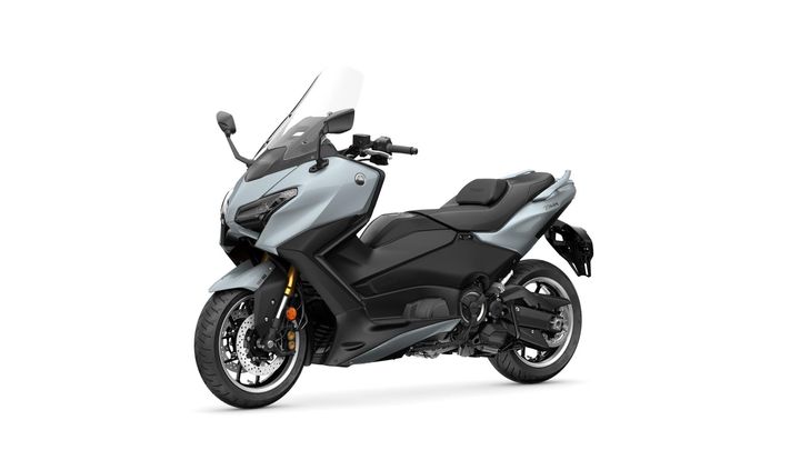 A sleek, modern scooter in a two-tone color scheme of light blue and black, featuring a windshield, a comfortable seat, and distinct styling, positioned at an angle to showcase its design and wheels.