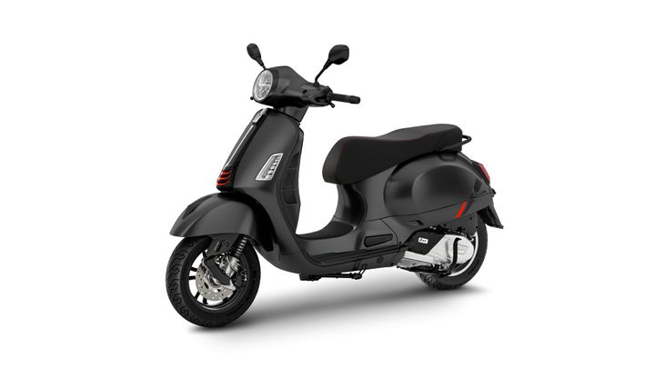 A sleek black scooter with a streamlined design, featuring a comfortable seat and modern handlebars, set against a plain white background.