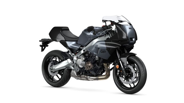 A dark gray motorcycle with a sleek design, featuring a prominent front fairing, a sporty frame, and dual exhaust pipes, positioned on a white background.