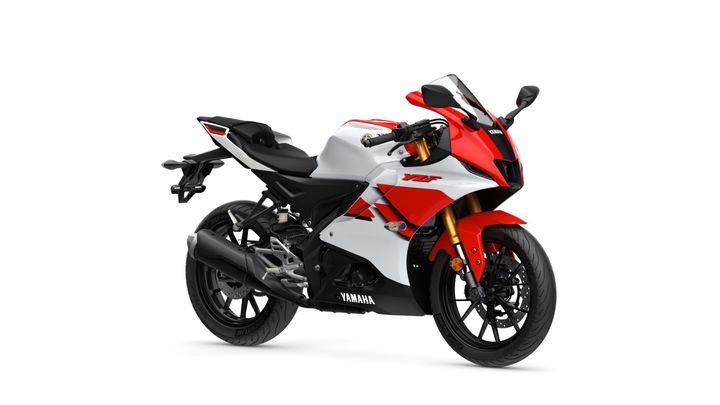 A sleek white and red Yamaha motorcycle with a aerodynamic design, showcasing prominent branding and stylish features against a plain white background.