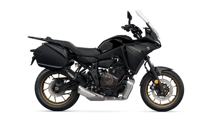 A side view of a black Yamaha motorcycle with gold rims, featuring a sleek design, prominent fairings, and integrated saddlebags.