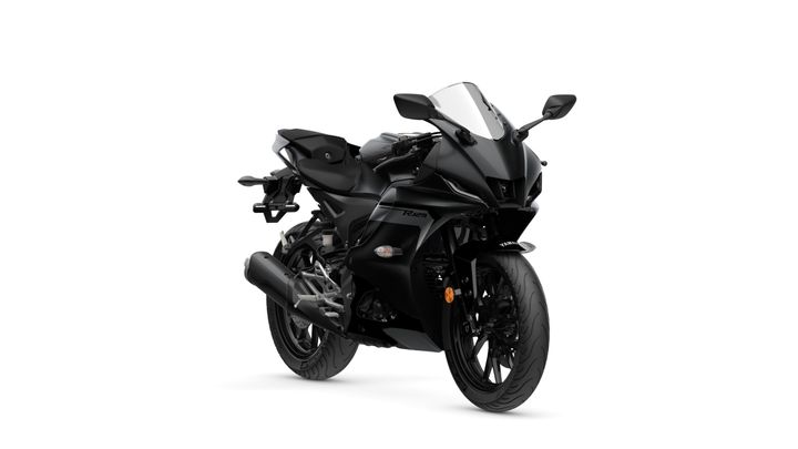A sleek, black sports motorcycle positioned at an angle, showcasing its aerodynamic design, front fairing, and intricate detailing on the wheels and exhaust.