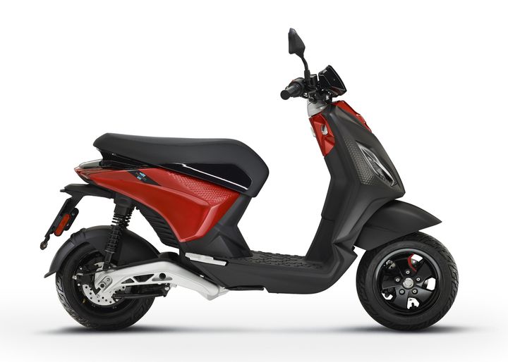 A modern red and black motor scooter on a white background.