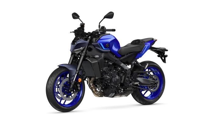 A blue and black sports motorcycle is displayed at an angle, showcasing its sleek design, large wheels, and modern features against a white background.