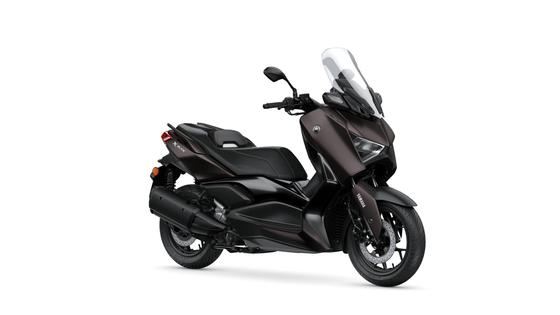 Yamaha 2024 XMAX 300 Tech MAX A sleek black Yamaha X-Max scooter, angled to showcase its modern design, windscreen, and stylish seat.