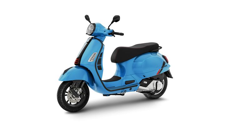 A light blue scooter with a sleek design, featuring a rounded body, black seat, and chrome accents, positioned at a slight angle on a white background.
