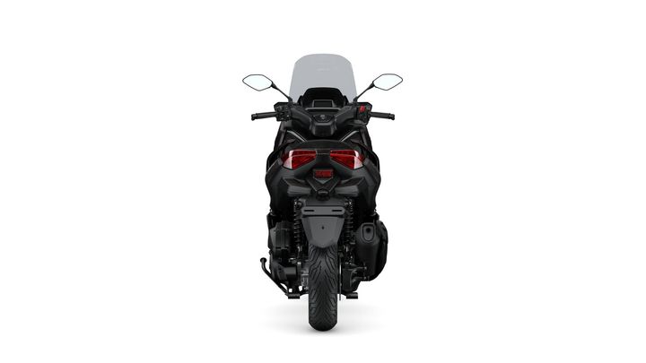 A rear view of a sleek black motorcycle with distinctive taillights, mirrors, and a windshield, set against a white background.