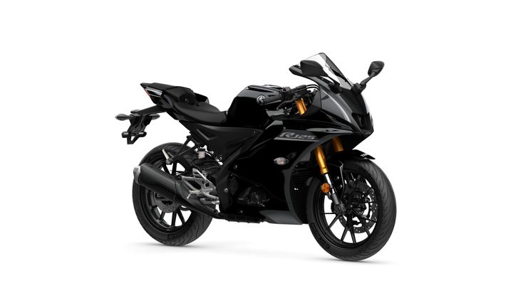 A sleek black sports motorcycle with gold accents, featuring a streamlined design and sporty posture, positioned at a slight angle against a white background.