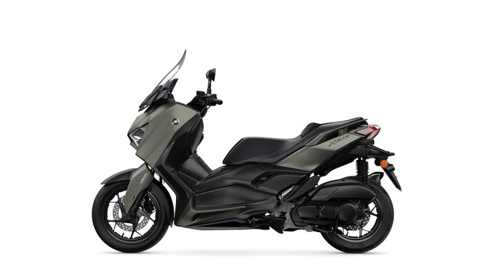 A sleek, modern scooter in a matte olive green and black color scheme, featuring a streamlined body, a tall windshield, and sporty wheels, displayed against a white background.