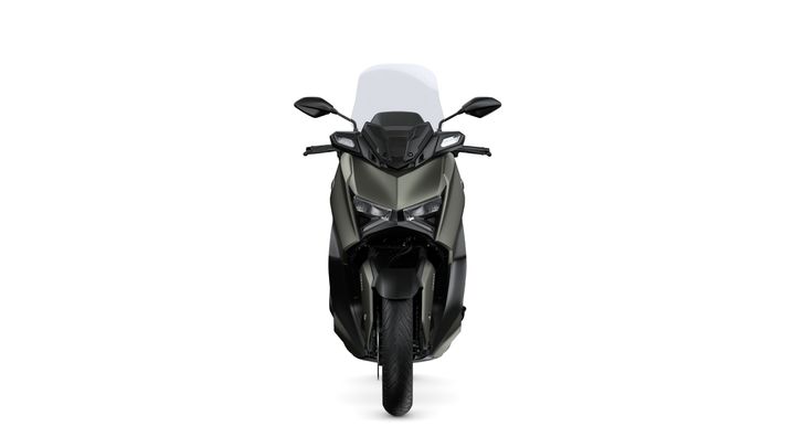 A front view of a sleek, modern motorcycle with an aerodynamic design, featuring a dark color scheme, prominent headlights, and a tinted windshield.