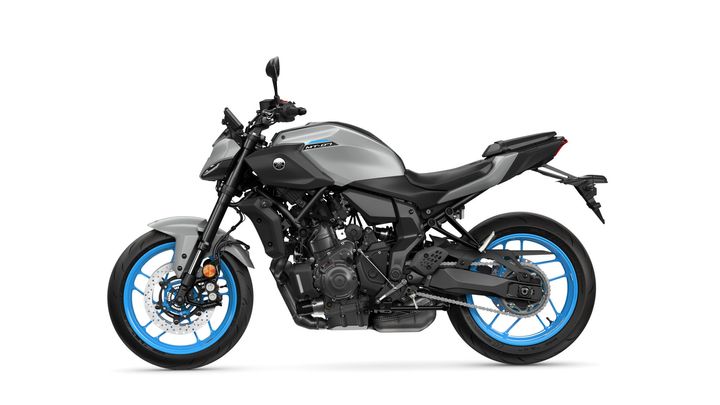 A modern motorcycle with a sleek gray body and striking blue rims, viewed from the side, showcasing its design and detailing.