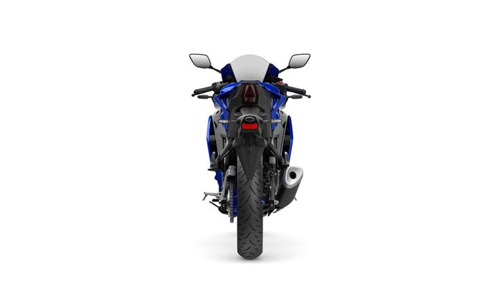 A blue and black sport motorcycle is displayed from the rear, showcasing its sleek design, prominent rear wheel, and exhaust pipe. The background is plain white, emphasizing the bike's features.
