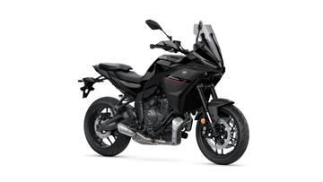 A sleek black motorcycle with a modern design, featuring a prominent front fairing, dual headlights, and a sporty frame, positioned at a slight angle.