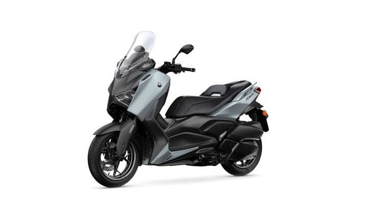 A sleek, modern Yamaha XMAX scooter in a two-tone gray and black color scheme, positioned at an angle to showcase its design and features.