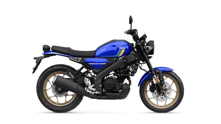 A blue Yamaha motorcycle with a sleek design, featuring a black seat, gold alloy wheels, and a modern headlight, is displayed against a white background.