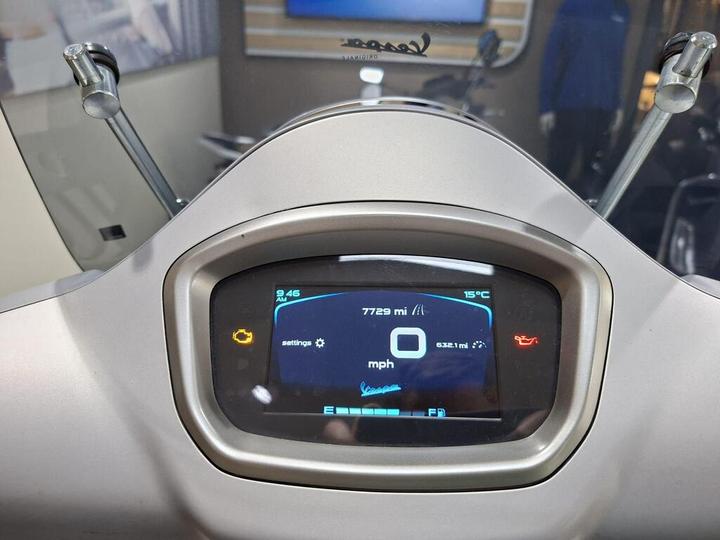 Dashboard display of a vehicle showing 7729 miles, current speed of 0 mph, trip distance of 632.1 miles, time of 9:46 AM, and a temperature of 15°C. Warning lights for maintenance and oil are illuminated.
