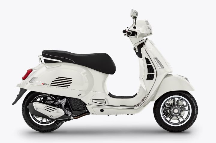 A white Vespa scooter positioned side-on against a plain white background.