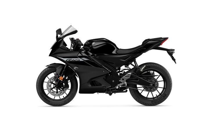 A sleek black sports motorcycle is displayed from the side, showcasing its aerodynamic design, sporty fairing, and large rear tire.