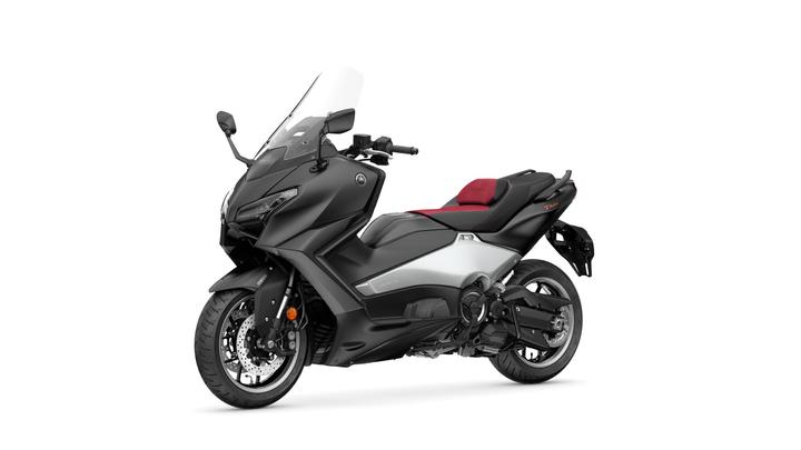 A black and silver Yamaha TMAX scooter, featuring a sleek design with a prominent windshield and a red-accented seat, positioned on a white background.