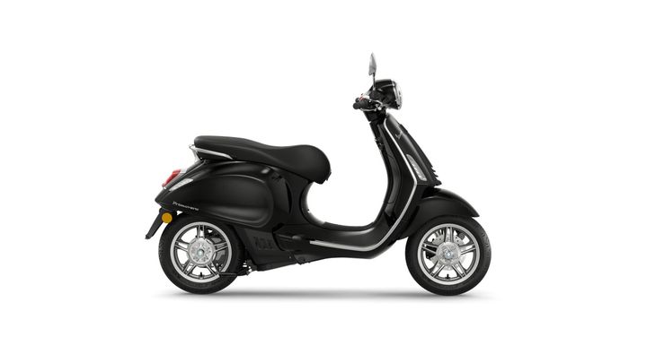 A sleek black scooter parked on a white background, showcasing its streamlined design and silver accents.
