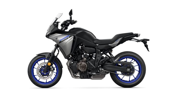 A sleek, modern motorcycle with a matte gray body and blue accents, featuring a sporty design and semi-faired front, viewed from the side.