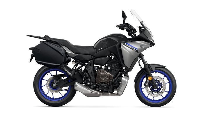 A sleek, modern motorcycle with a silver and black design, featuring blue accents on the wheels and a side luggage compartment.