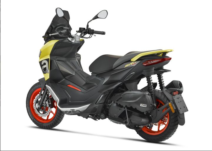 A modern black and yellow sporty scooter with red-accented wheels, displayed in profile view on a plain background.