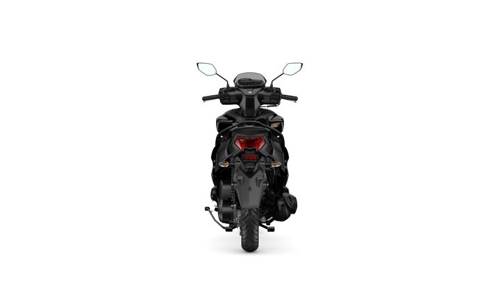 A black scooter viewed from the rear, featuring a sleek design, prominent headlights, and a modern dashboard with handlebars.