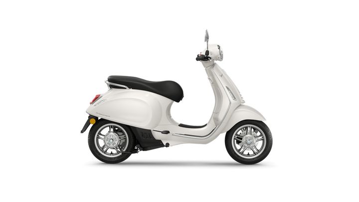A white scooter with a black seat and chrome details, viewed from the side against a white background.