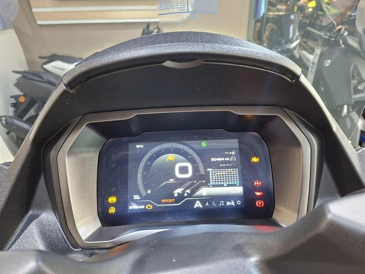 Dashboard display of a motorcycle, featuring a digital speedometer showing 0 mph, odometer reading 20,454 miles, temperature in °C, and various indicator lights including sport mode and warnings.