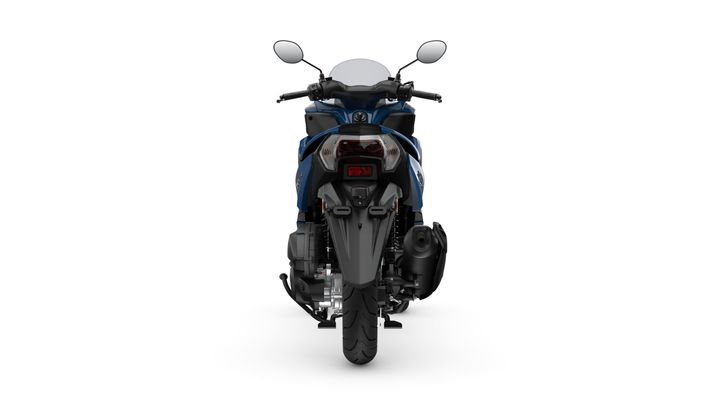 A rear view of a blue motorcycle showcasing the rear wheel, exhaust, and tail lights on a white background.