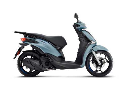 A blue scooter, the Liberty S, is shown in profile, featuring a sleek design, a comfortable seat, and distinctive wheels with blue accents.