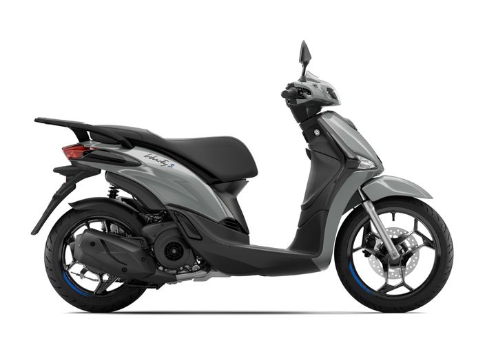 A modern grey scooter, the Liberty S, shown from the side, featuring a sleek design, a comfortable seat, and a distinct rear light.