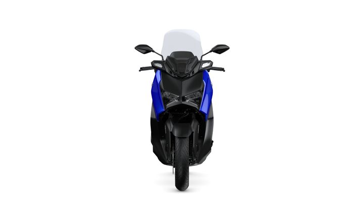 Front view of a blue and black scooter, showcasing its sporty design, headlights, and windscreen against a white background.