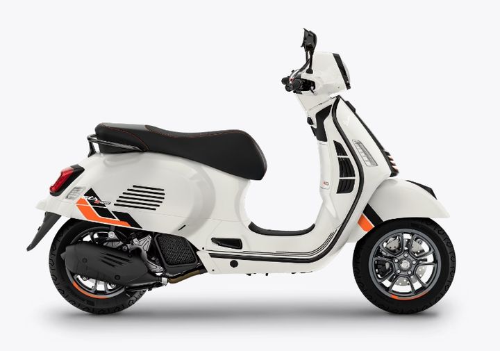 A white modern scooter with a black seat and orange accents on a white background.