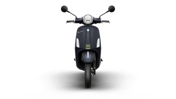 Front view of a dark blue scooter with a round headlight, black mirrors, and a sleek design.