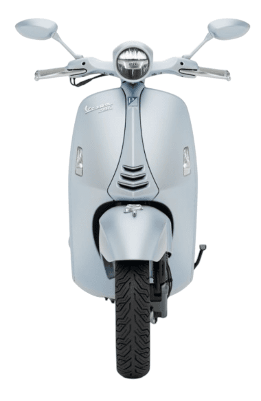 Front view of a light blue Vespa scooter, featuring a sleek design with chrome accents, a round headlight, and classic circular mirrors.